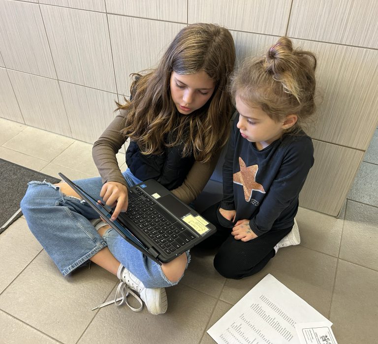 Older students helping younger student during Math Buddies session