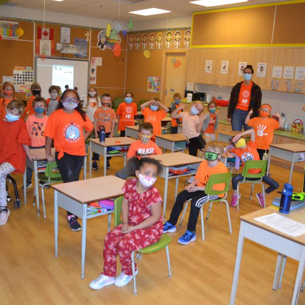 class of students in orange shirts