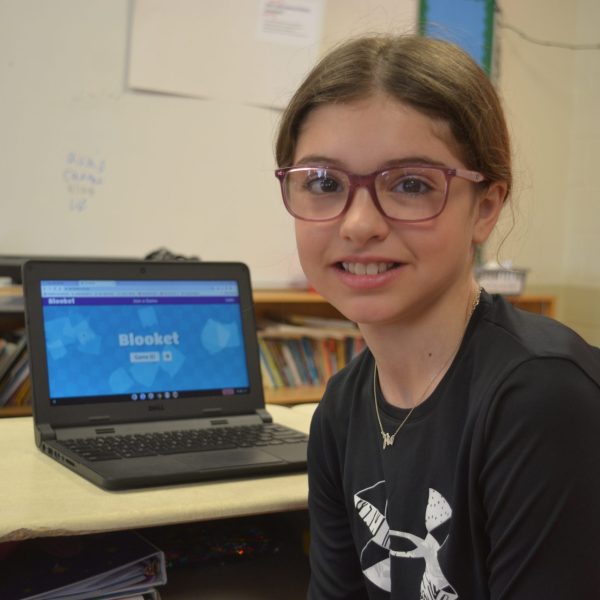 Female student at desk in classroom