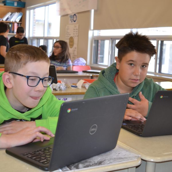 Male students at computers in classroom