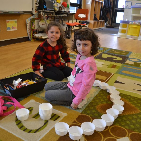 Two kindergarten students playing on the floor