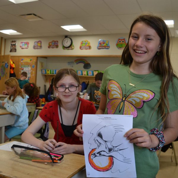 Female student shows off her artwork