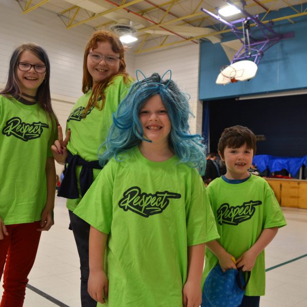 Four students with shirts that say respect