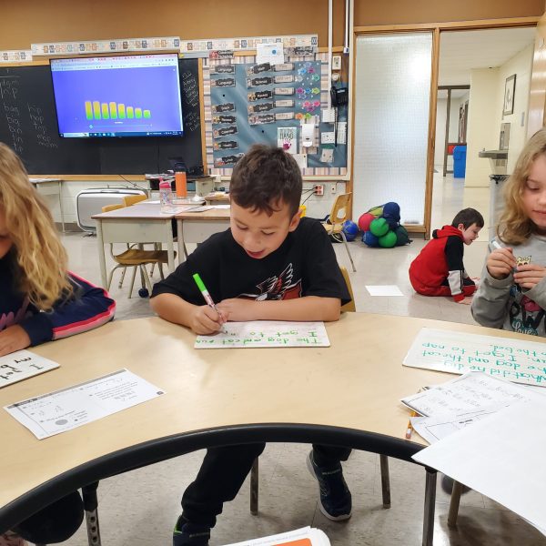 Students writing at a table