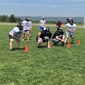 female football players practice offensive line setup