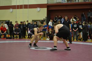 Male SMC wrestler begins match