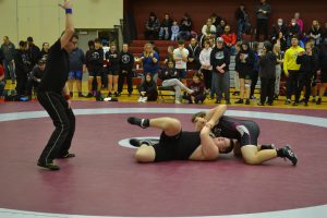 Male SMC wrestler gains upper hand on opponent