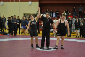 Male SMC wrestler wins match