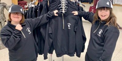 Two students showing SMC clothing