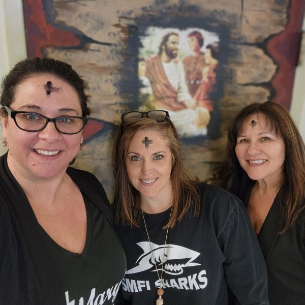 Three teachers with ashes on their foreheads