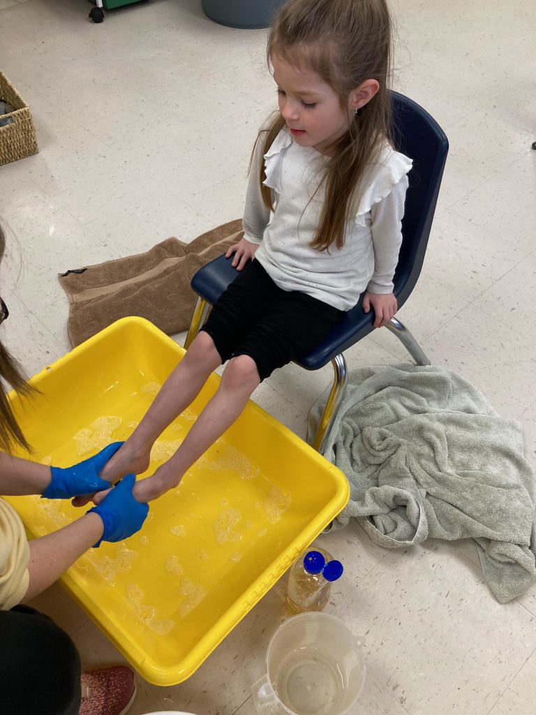 girl having feet washed