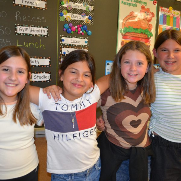 four female students in front of chalkboard