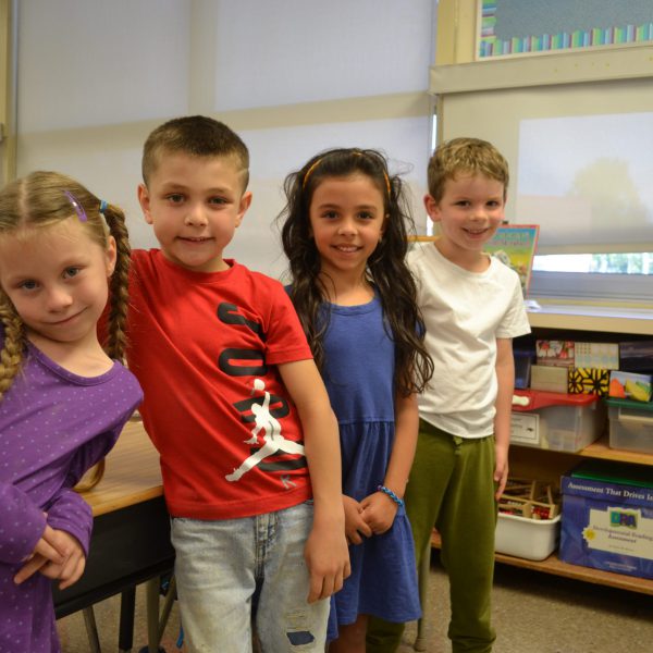 four students standing together