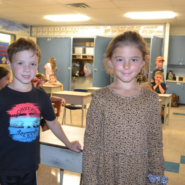male and female student smiling at camera
