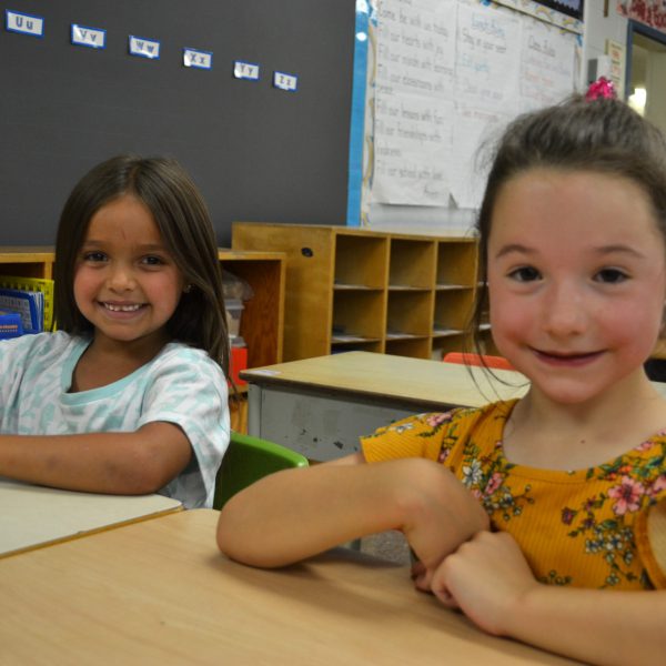 two students sitting at their desks